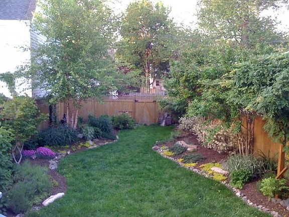 Fenced in backyard garden - Service Alley in behind property