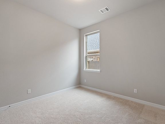 Cozy in-law suite bedroom featuring a private bath, offering comfort and privacy in a serene setting