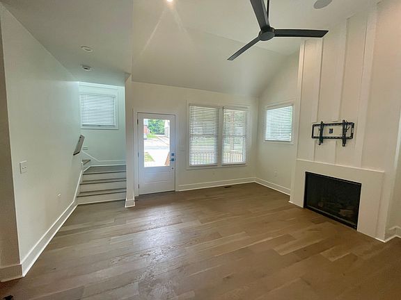 Living room to front door and stairs. A television mount is already installed over gas fireplace for convenience.