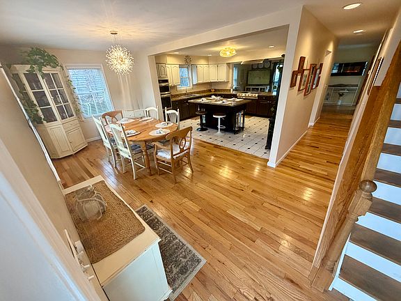 Entering the home to open concept dining area & kitchen. Family room & sliding glass doors lead to deck, pool & backyard. Bonus room to right. Stairs to 3 bedrooms. Main floor includes spacious bedroom, 1.5 baths & laundry