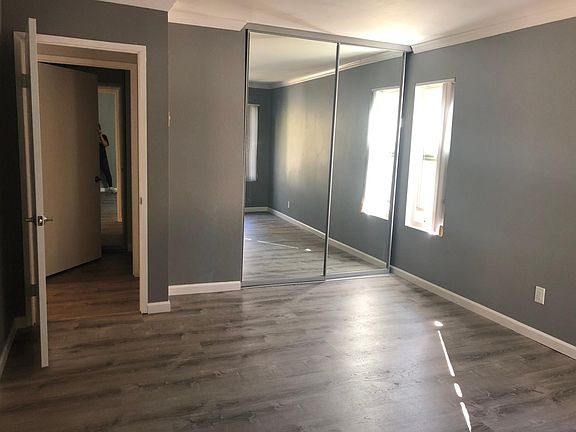 Large closet in bedroom with new floors, paint and crown molding