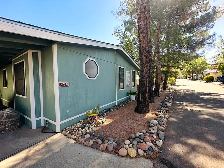 Front of home with carport for two vehicles.