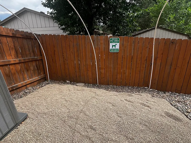 Designated pet relief area with pea gravel surface, helping to keep the backyard clean and enjoyable for everyone. Please pick up after your pet and dispose of waste in the outdoor trash receptacle.