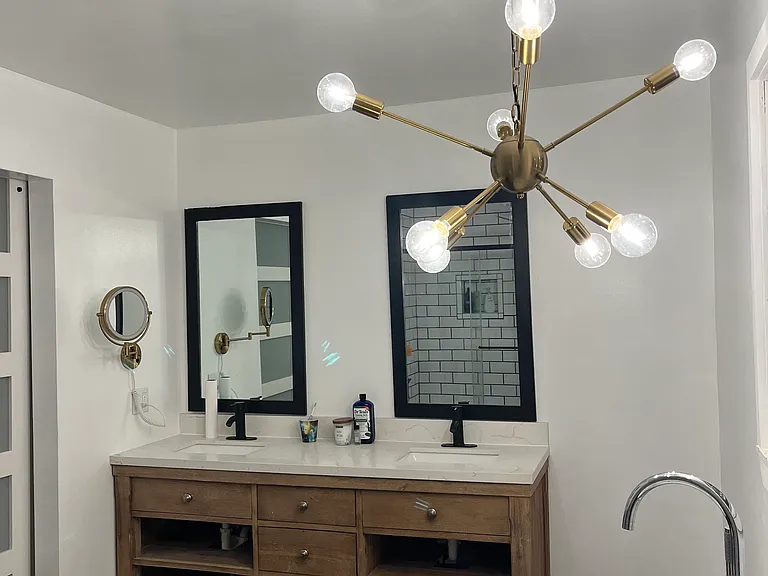 Primary bathroom with large dual vanity and free standing tub
