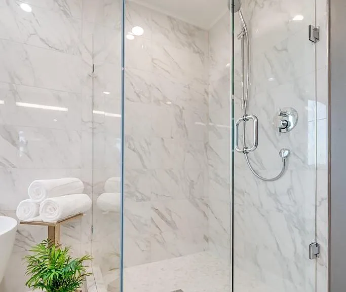 Luxurious master bath with double shower heads and stunning marble throughout