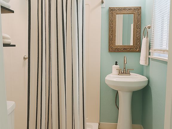 Bathroom with shower. Window for natural light and ventilation.
