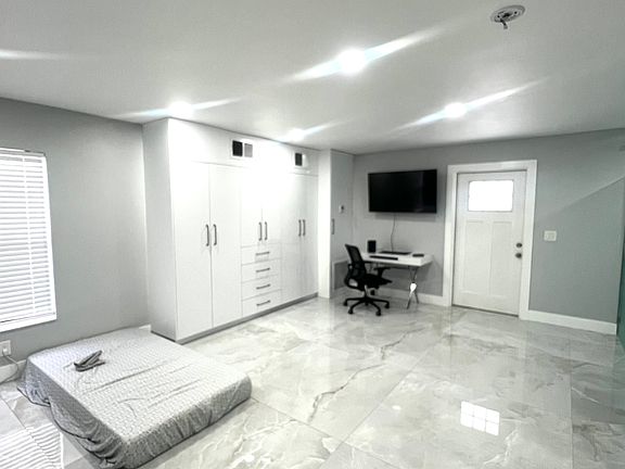 View of custom closet in separate apartment or second master bedroom. Apartment includes separate entrance as well.