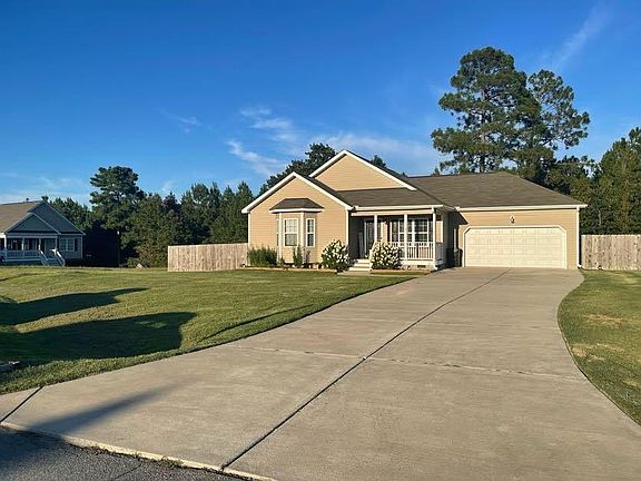Another front of house angle, showing vast driveway.