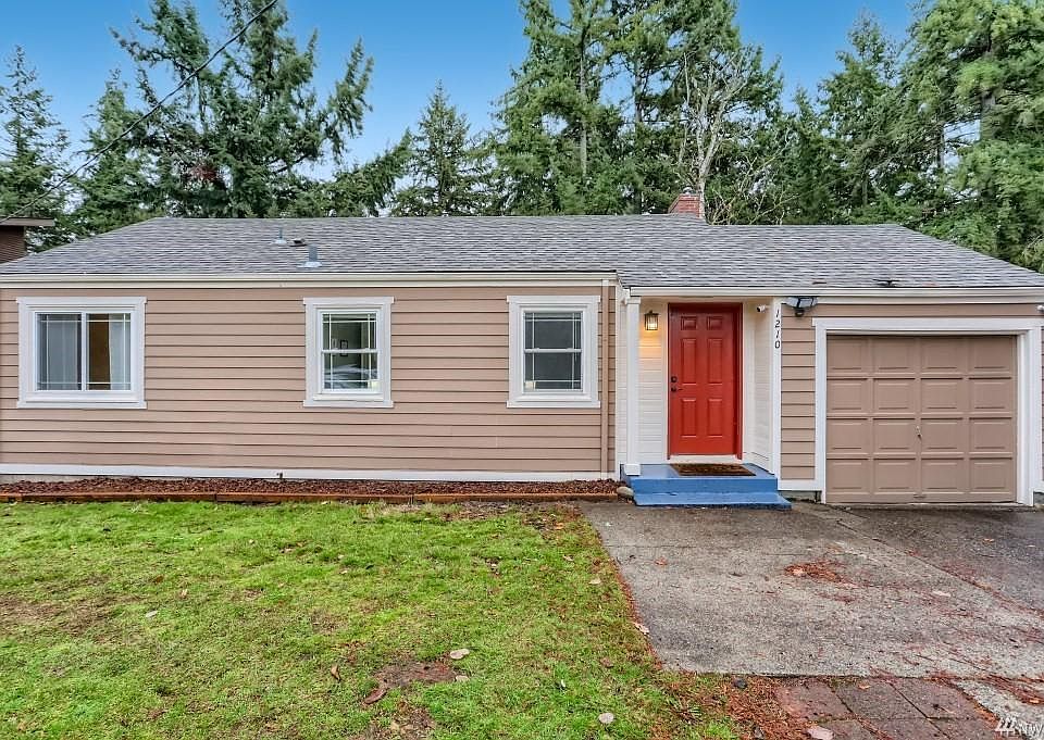 Front of the property - greeted by a bright red door leading to an updated interior of the house.