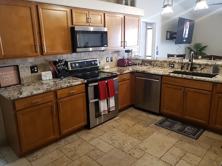 Modern kitchen with stainless appliance pkg. R/O water system coffee station and all amenities for your stay. Crock pot, air fryer, stand mixer. Kettle for your use along with Keurig coffee machine.