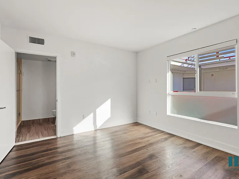 Bedroom with Bathroom, Vinyl Flooring, and Large-Size Windows