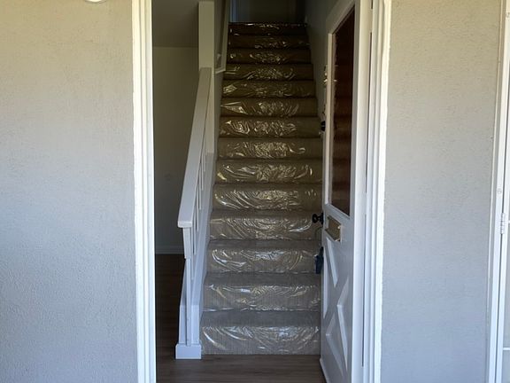 Living room to left, stairs lead to two bedrooms and 1 full bath
