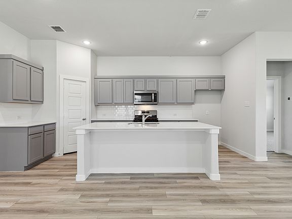 Kitchen in the Quartz home plan by Trophy Signature Homes - REPRESENTATIVE PHOTO