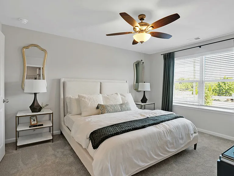 Bright bedroom with ceiling fan and private en-suite bathroom
