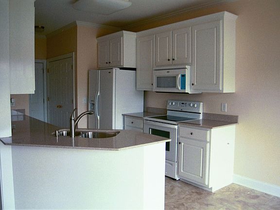 Kitchen with all new white appliances and Kohler faucet