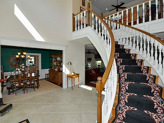 THE FOYER HAS A CUSTOM CURVED STAIRCASE THAT LEADS UPSTAIRS, HAS A TRAVERTINE TYPE TILE  FLOORING & TWO STORY CEILING. LOTS OF NATURAL LIGHTING COMES THROUGH THE UPPER WINDOWS FOR A GREAT WELCOME TO THIS HOME.