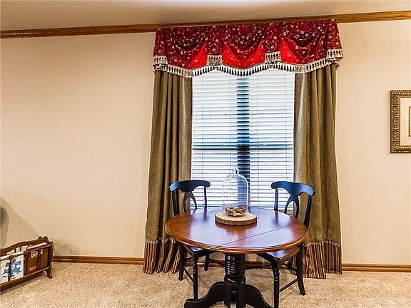 Dining area with custom window treatments.