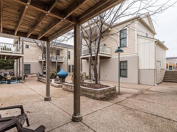 A view from the covered patio area of the condo to the planting and common area of the courtyard.