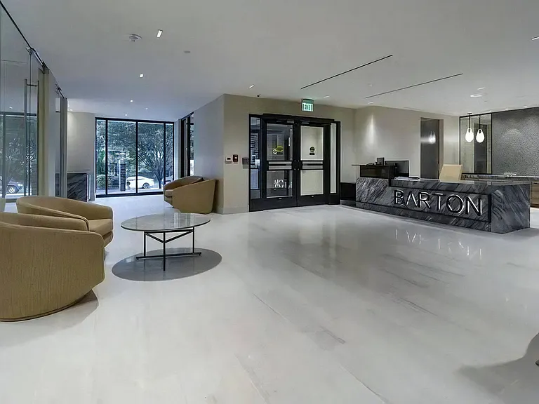 Lobby Entry With Armchairs, Coffee Table, and Reception Desk