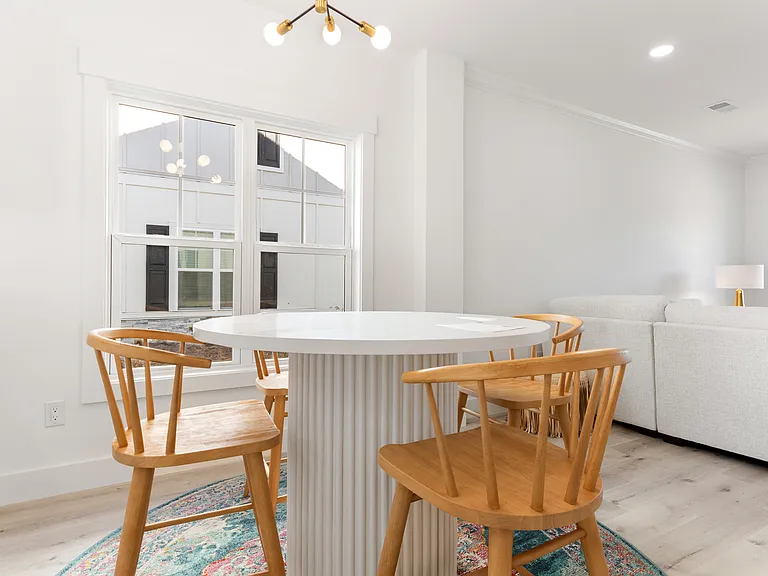 Bright dining area. Two-inch faux wood blinds will be installed.