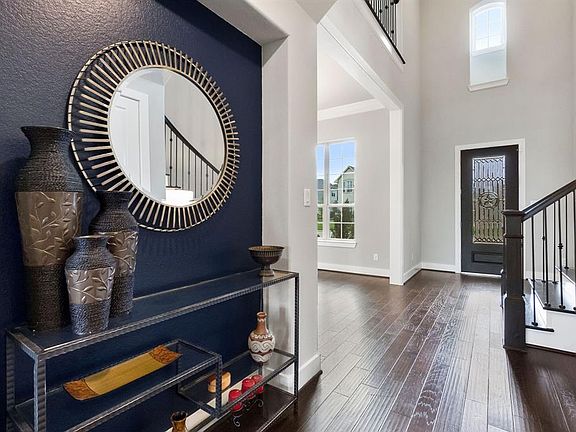 View from the other side of the entry where you can see the dining room to the left and the study with doors to the right.