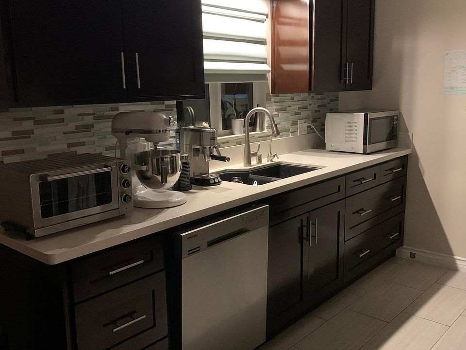 roman blind above sink, matching blind in dinning area. recessed lights.