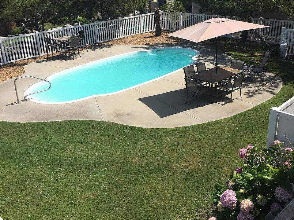 view from the deck overlooking inground pool
