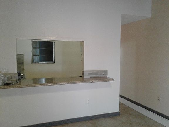 Looking into the kitchen from dining area with breakfast bar.
