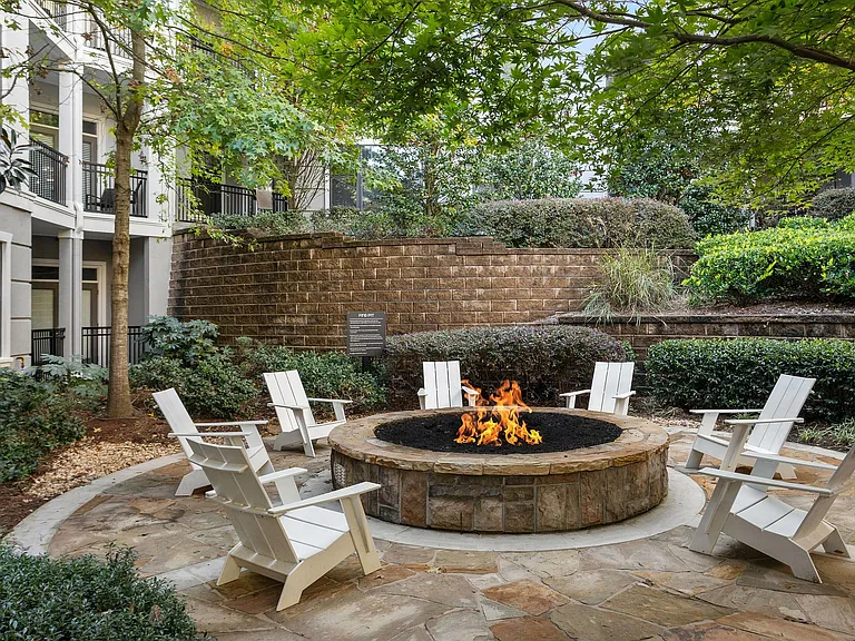 Experience serene relaxation by the fire in this beautifully landscaped outdoor space.
