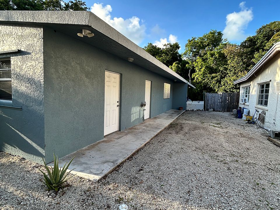 Side of yard. Side Door From Kitchen. 2nd Door is Storage
