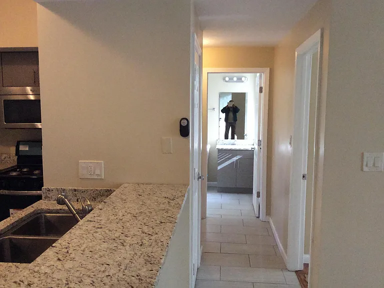 Hallway view from kitchen into 2nd bathroom