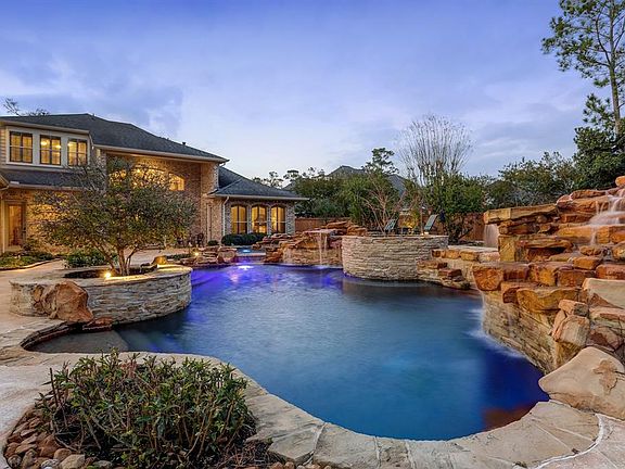 Another view of the STUNNING backyard oasis from the end of the pool looking back towards the house.