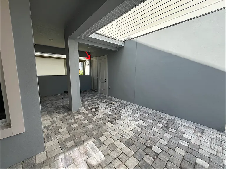 Entrance door is beside garage door