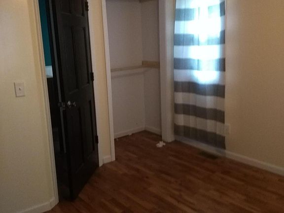 Bedroom 1 with original hardwood floors.