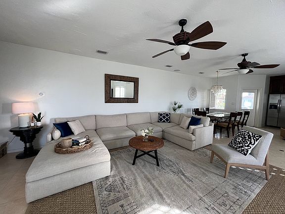 Very large comfortable living room with views looking out to the bay.