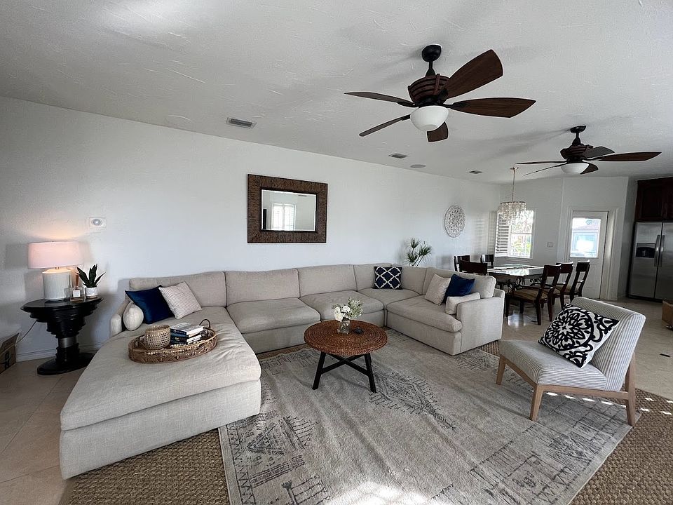 Very large comfortable living room with views looking out to the bay.