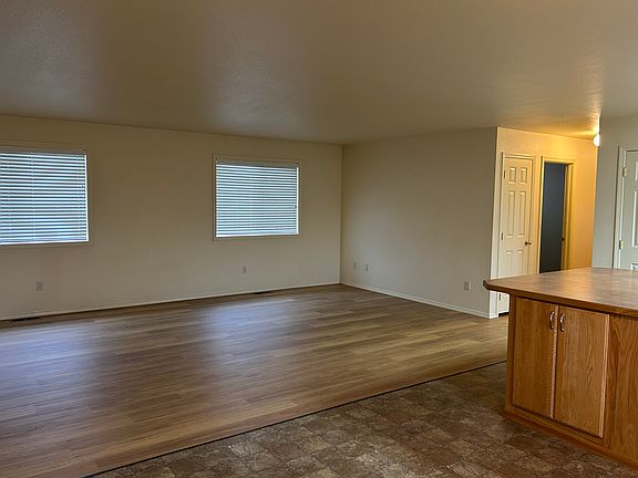 View from front door of family room, dining room and kitchen to the right.