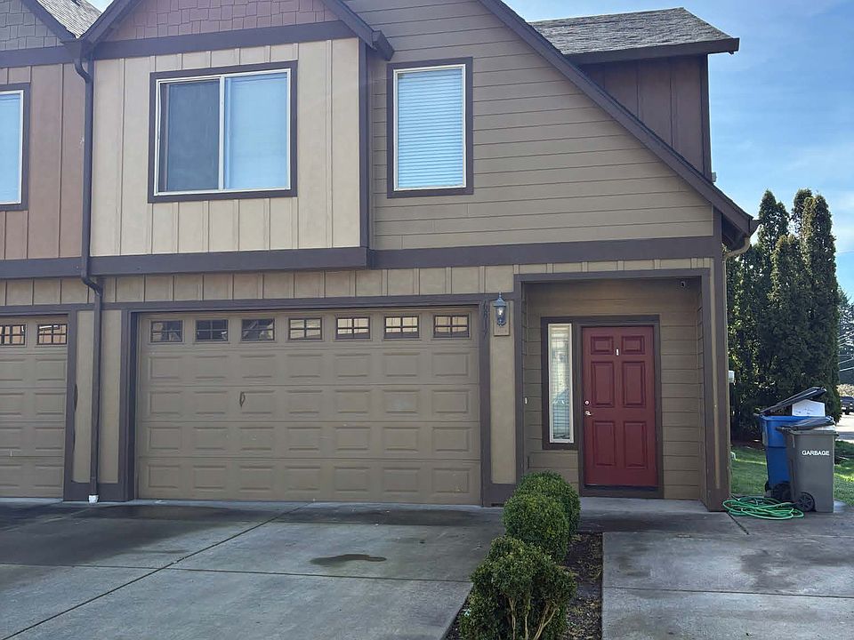Front of unit with 2 car garage, and three parking spaces in front.