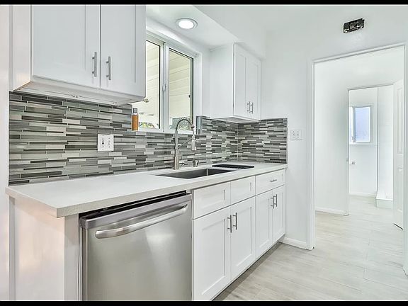 New kitchen cabinets, faucet, quartz counter tops and tile floor