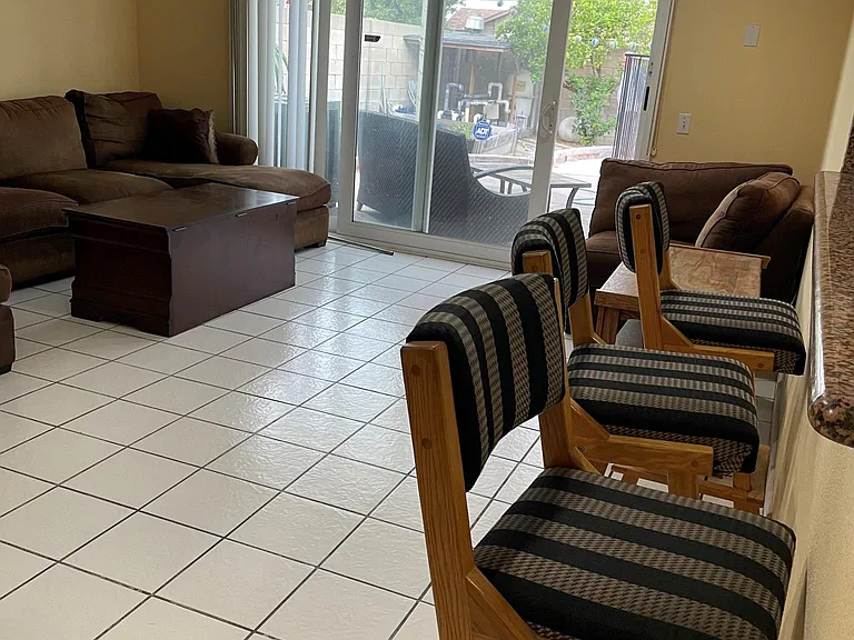 Family room with stool to the right and easy kitchen access