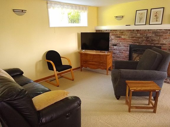 Couch has built-in recliners, comfy chair for reading.