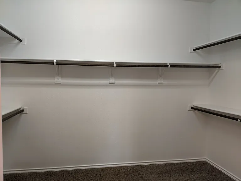 large walk-in closet in primary bedroom