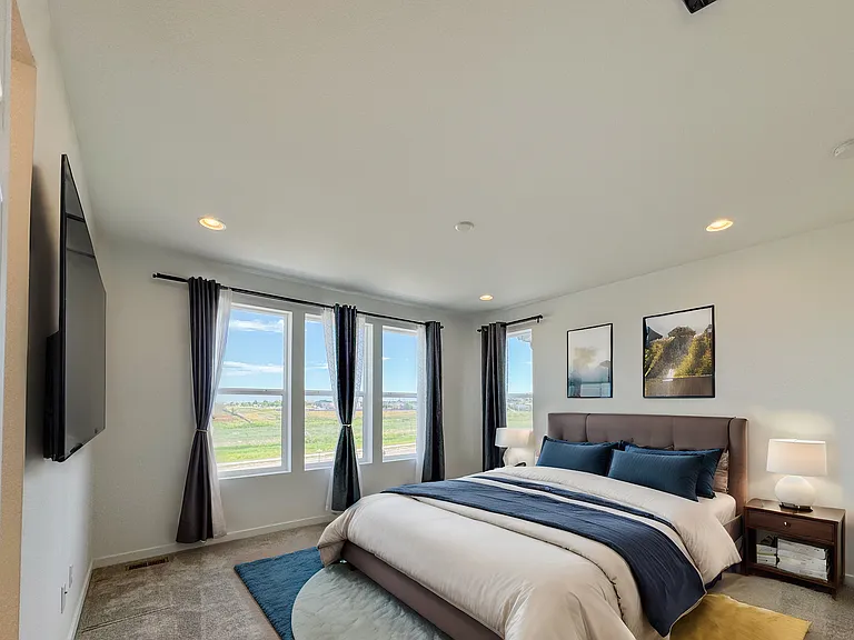Warm, comfortable master bedroom with plenty of natural light