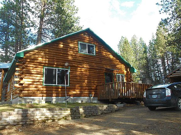 Driving up to log cabin