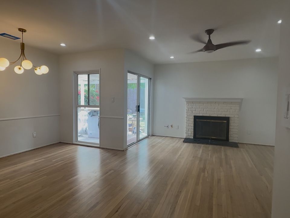 Living Room and Dining Room with Sliding Door that leads into Backyard