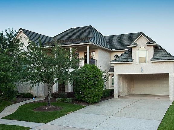 Beautiful Bayou Bend Custom Home is all brick and has a tile roof.
