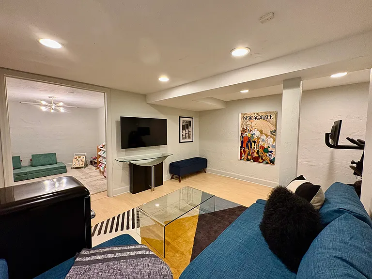 Lower level main room with attached multi-purpose flex space perfect for a playroom, hobbies, or an extra office
