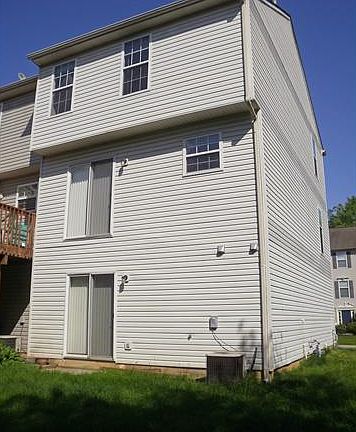 Rear view of townhome and slider to Family Room