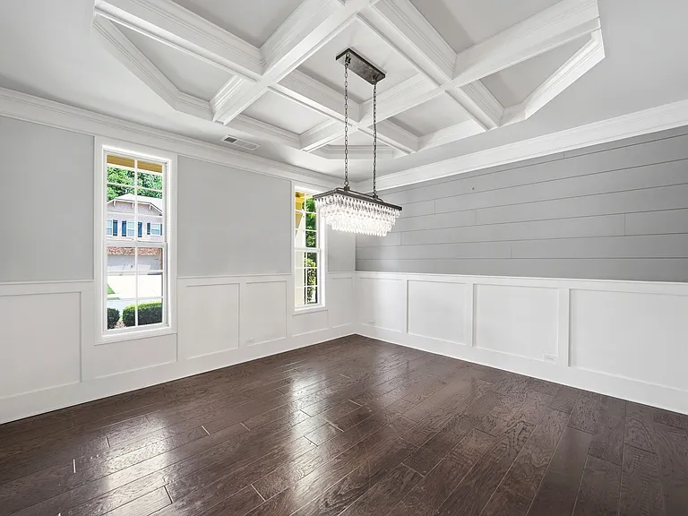 Formal dining room accented with coffered ceiling