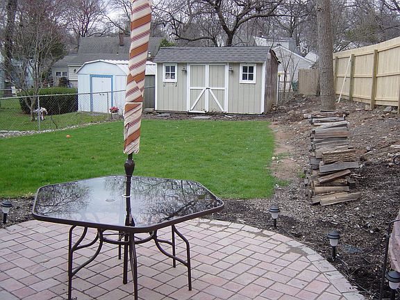 nice yard with new paver patio, new wood fence and shed